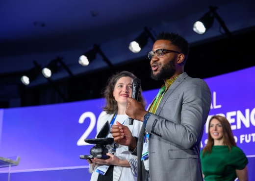 Runner-up Randy Kabuya and Deney van Rooyen of Omnivat on stage at the 2024 Global Conference